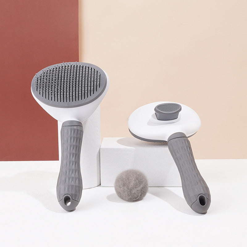 Gray GroomPro pet grooming brush side profile showing non-slip rubber handle and stainless steel pins

