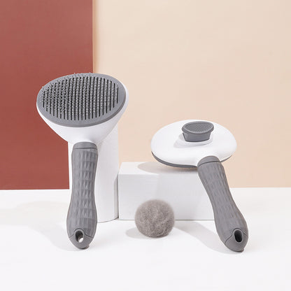 Gray GroomPro pet grooming brush side profile showing non-slip rubber handle and stainless steel pins

