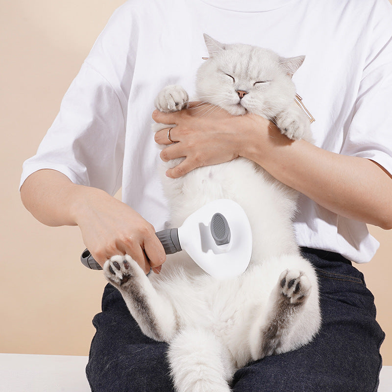 GroomPro grooming brush self-clean button detail — one push releases collected pet fur instantly

