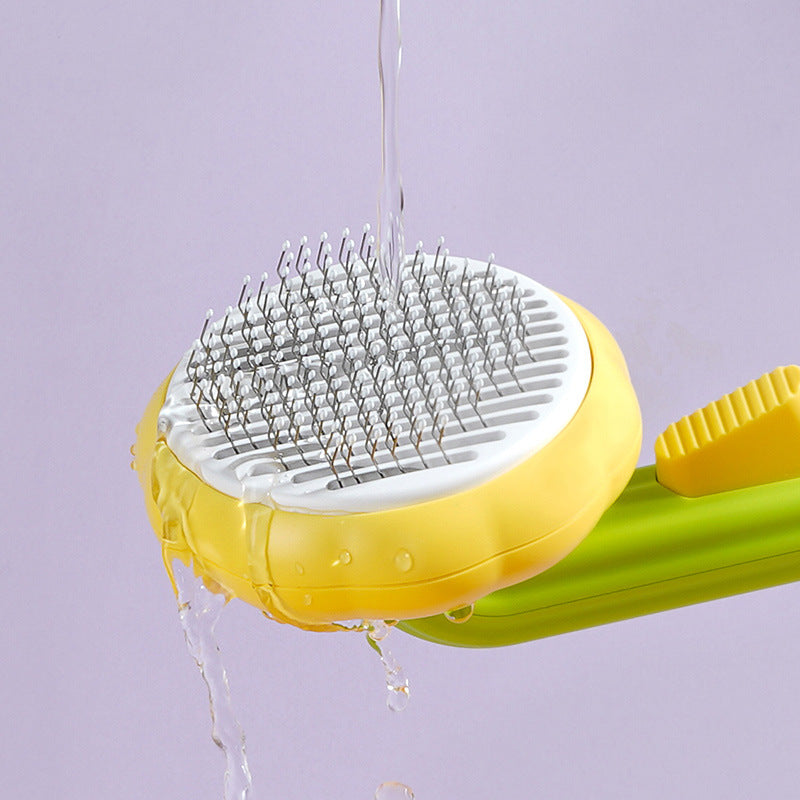 PetGroom pet grooming comb held in hand showing size — 195mm compact design for cats dogs and small pets

