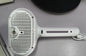 Pet grooming brush misting water onto dog coat while brushing